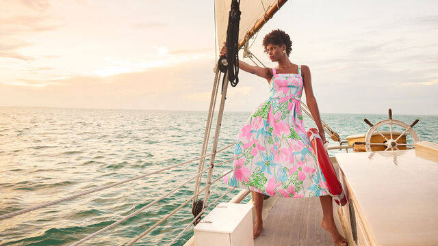 Model on boat in floral midi dress